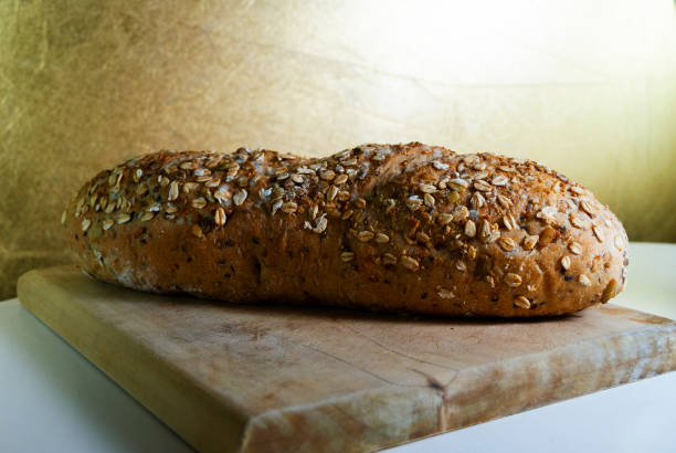 Healthy sliced bread on rustic wooden board, seed bread source of energy, carbohydrates and fiber, traditional flavor in Guatemala