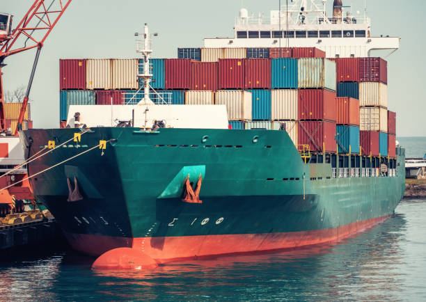istock Harbor crane unloads containers from cargo ship at pier. Logistics, international trade transportation. Import and export of goods 1470958905