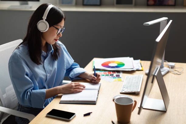 istock Portrait Of Female Asian Designer Writing In Notebook 1470959084