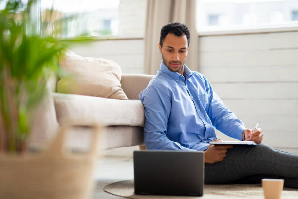 istock Portrait of young Arab man using laptop and writing 1470959300