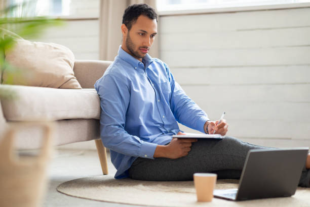 istock Portrait of Arab man using laptop and writing 1470959308