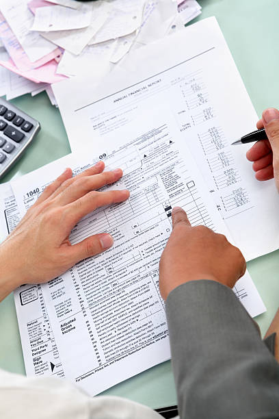 istock Guiding people to fill tax form 147095940
