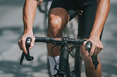 close up asian chinese male cyclist hands cycling in cycling event