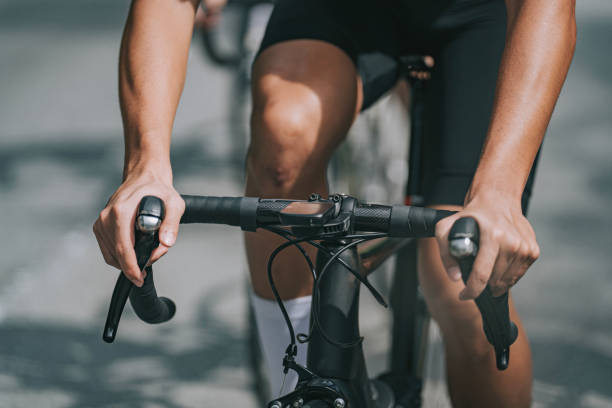 close up asian chinese male cyclist hands cycling in cycling event - road cycling imagens e fotografias de stock