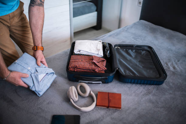 istock Man packing his suitcase for a vacation. 1470959876