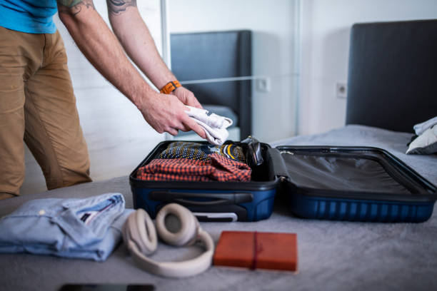 istock Man packing his suitcase for a vacation. 1470959882