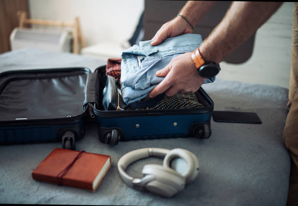 istock Man packing for a business trip. 1470959897