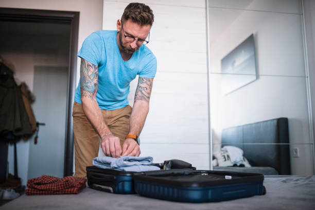 istock Man preapring his luggage for a trip. 1470959905