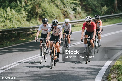 istock Asian Chinese female cyclist leading in rural cycling event 1470960651