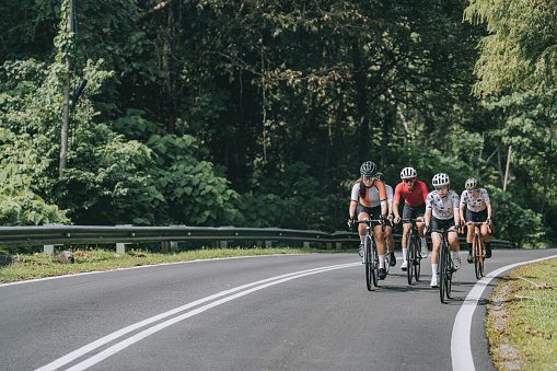 Asian Chinese female cyclist leading in rural cycling event