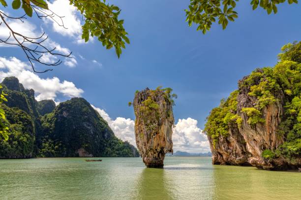 istock a large rock formation sits in a lagoon in thailand, surrounded by trees 1470961965