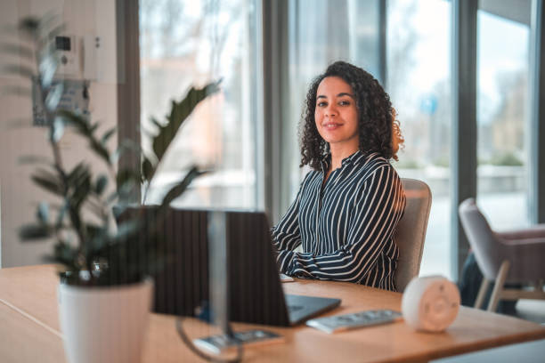 istock Lovely Hispanic Businesswoman Using Laptop In A Modern Office 1470962044