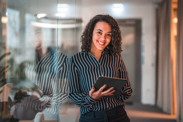 istock Lovely Hispanic Businesswoman Using Digital Tablet In A Modern Office 1470962049