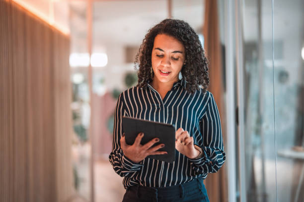 istock Lovely Hispanic Businesswoman Using Digital Tablet In A Modern Office 1470962053
