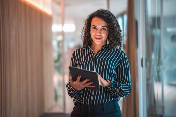 istock Lovely Hispanic Businesswoman Using Digital Tablet In A Modern Office 1470962058