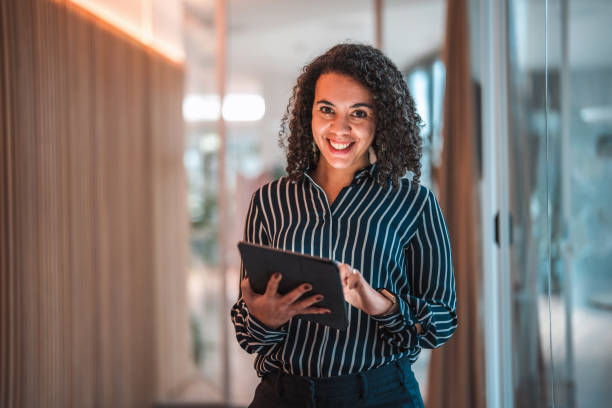 istock Lovely Hispanic Businesswoman Using Digital Tablet In A Modern Office 1470962065