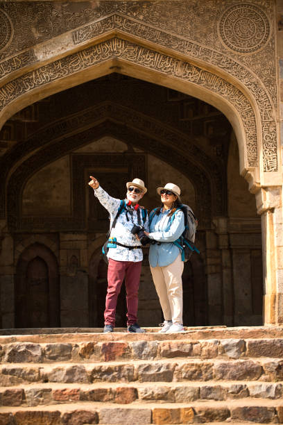 istock Old couple tourist looking up at ancient architecture 1470962348