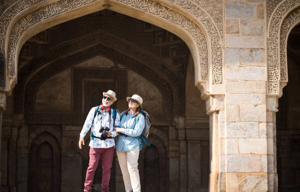 istock Old couple tourist looking up at ancient architecture 1470962379