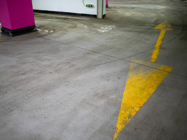 istock shabby yellow traffic direction sign in parking 1470966203
