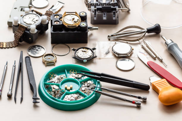 spare-parts, tools and used watches on wood table stock photo