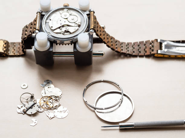 spare parts for old wristwatch on wooden table stock photo