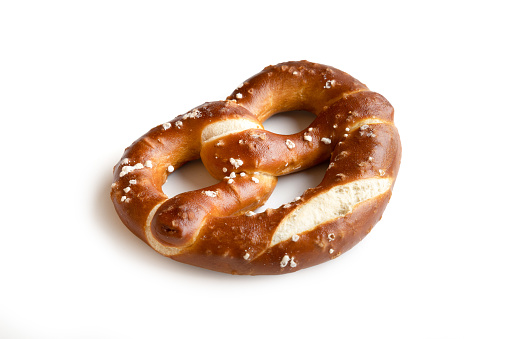 Single salted pretzel on white background