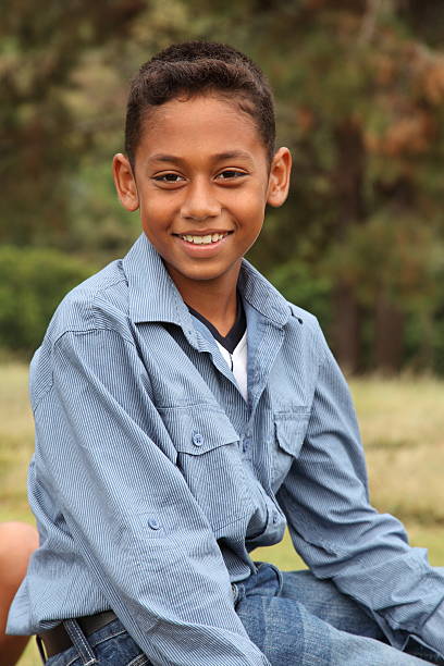 istock Young ethnic boy with big smile in the park 147096717