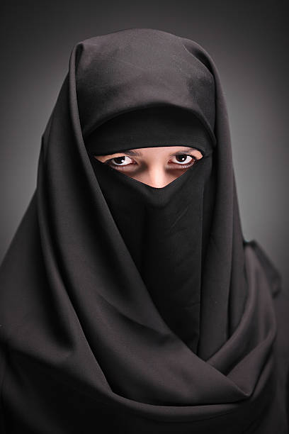istock Veiled Muslim woman with dark background 147096723