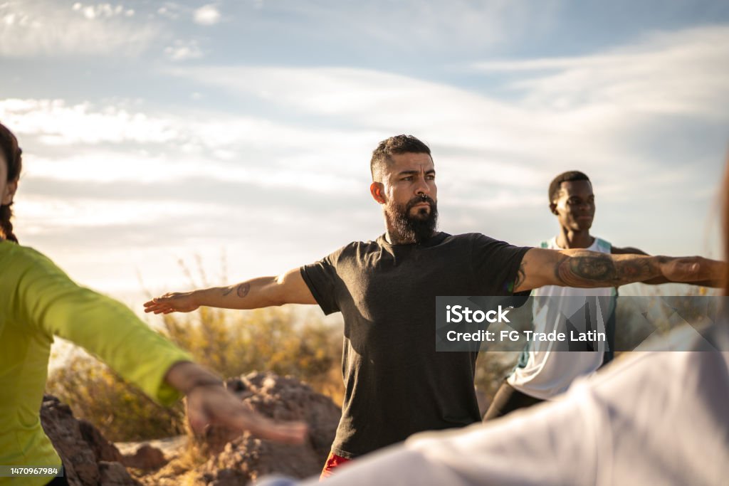Mature man during an yoga class outdoors Yoga Stock Photo