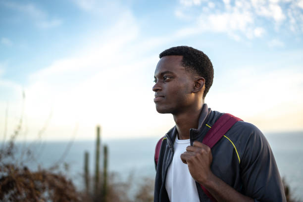 istock Young man contemplating while hiking outdoors 1470968598