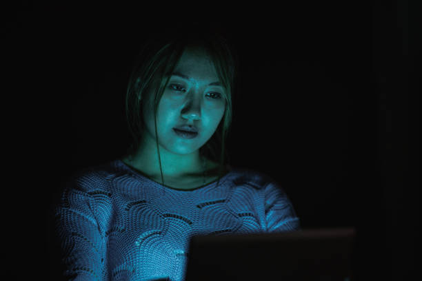 istock Woman using digital tablet in the dark 1470969537