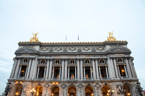 Paris, France – September 23rd, 2022: The Palais Garnier, also known as Opéra Garnier, is possibly the most famous opera house in the world - partly due to its use as the setting for the novel 'The Phantom of the Opera'. Photographed here at the end of the afternoon.