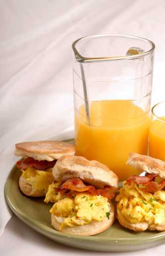 Scrambled egg and bacon biscuits with orange juice