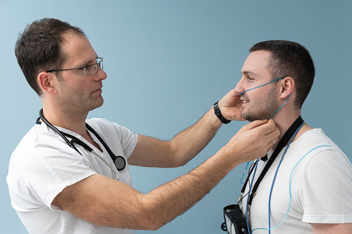 Doctor preparing patient for polysomnography (sleep study)