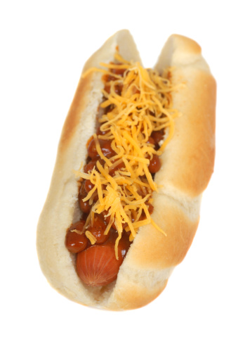 Hotdog with mustard in hand. Isolated in a white background. Close-up.