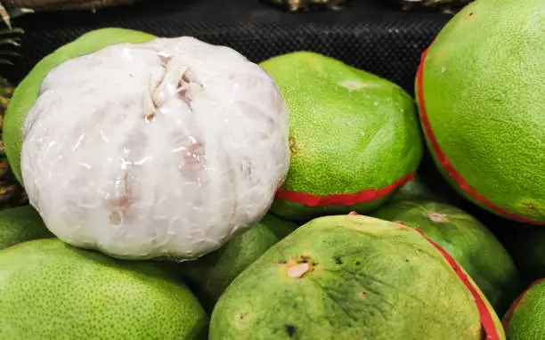 Photo of Big orange fruit or pomelo in supermarket. Fresh and healthy fruit.