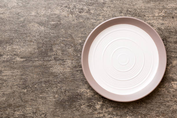 istock Top view of empty light plate on cement background. Empty space for your design 1470974139