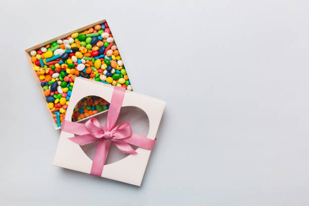 istock Box with sweet chocolate candies on color background, Various candy sweets. Valentines day gift box. Top view flat lay with copy space 1470974227