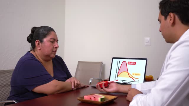 Overweight latin woman listening to doctor about glycemic index curve