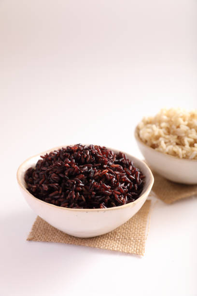 istock Organic boiled brown rice on bowl isolated in white background 1470975347