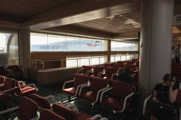 Arrival entrance gate decorated with art carvings in Auckland International Airport terminal building, New Zealand.