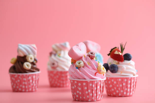 istock Colorful cupcakes isolated in pink background 1470975872