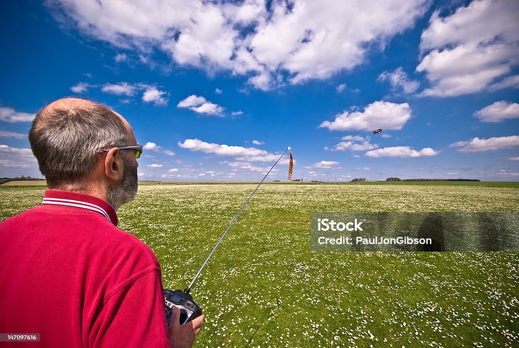 Model Plane Enthusiast On a fine sunny day this is a man indulging in his favorite hobby, flying model airplanes. Airplane Stock Photo