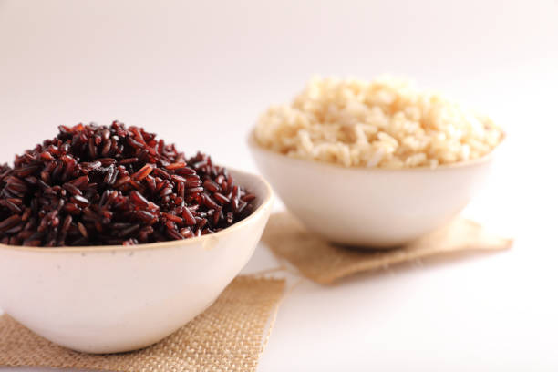 istock Organic boiled brown rice on bowl isolated in white background 1470977589