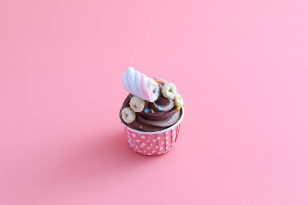 istock Chocolate cupcake isolated in pink background 1470978129