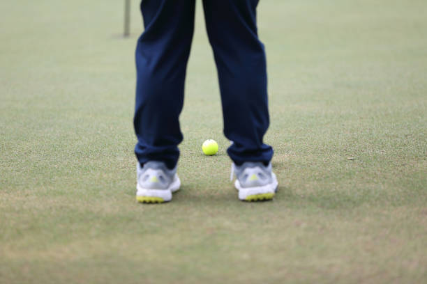 istock Golf ball on green grass ready to be struck on grass background 1470979255