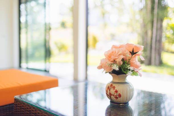 pink flower in jar on wood table with space for text