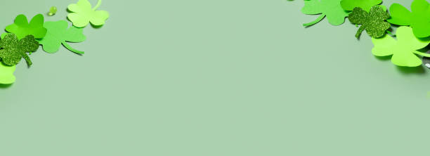 istock St. Patrick's Day minimalistic banner. Paper clover leaves on colored background with copy space 1470981164