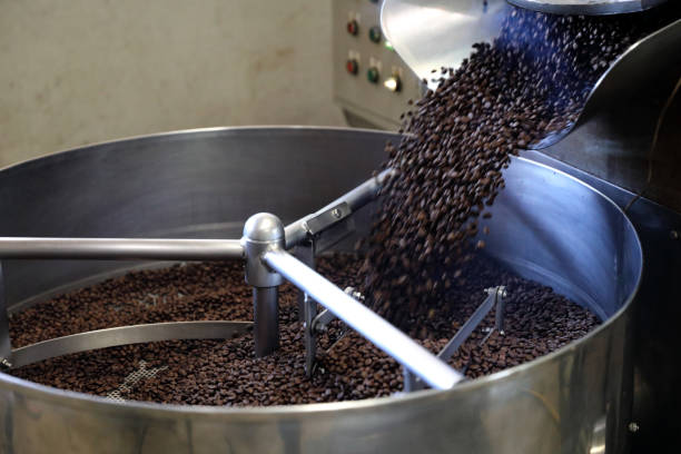 istock Coffee beans roasting with machine in close up 1470981269