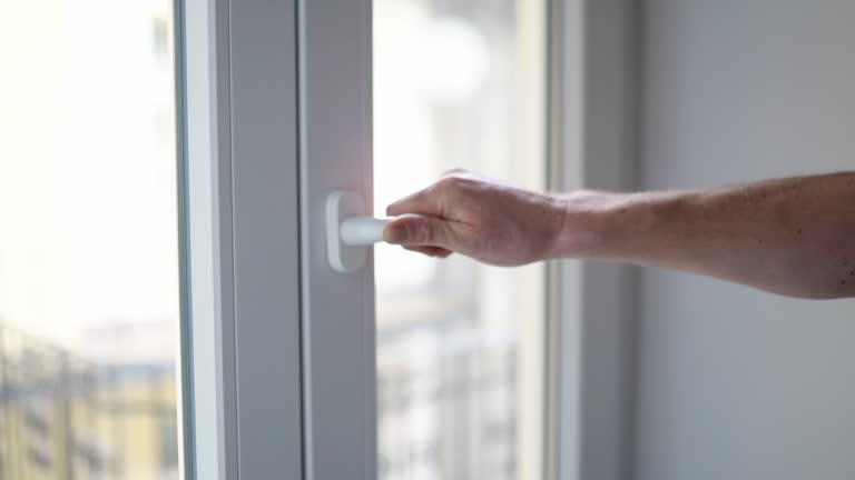 Man closes a plastic window